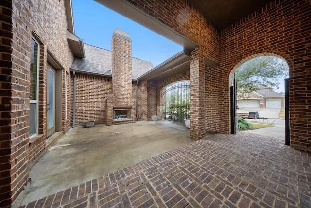 view of patio with exterior fireplace