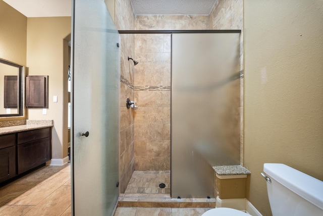 bathroom with vanity, toilet, and a shower with door