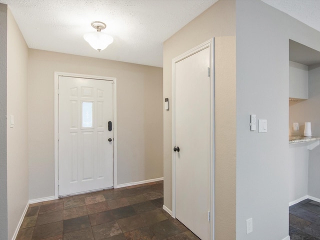 foyer entrance featuring a textured ceiling