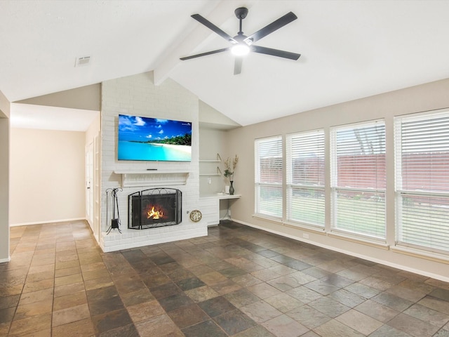 unfurnished living room with a brick fireplace, vaulted ceiling with beams, a wealth of natural light, and ceiling fan