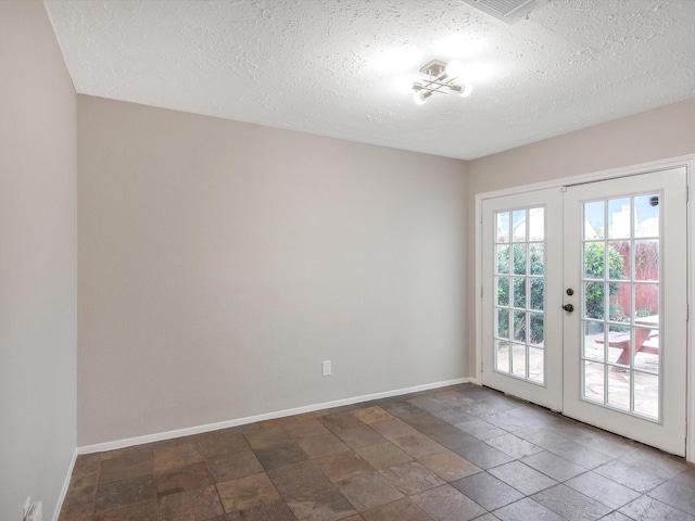 doorway to outside featuring a textured ceiling and french doors