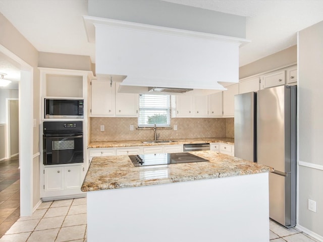 kitchen with sink, black appliances, white cabinets, and a kitchen island