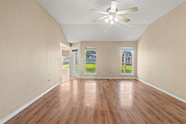 unfurnished room with ceiling fan, vaulted ceiling, and light hardwood / wood-style flooring