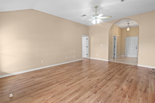 spare room featuring lofted ceiling, ceiling fan, and light wood-type flooring