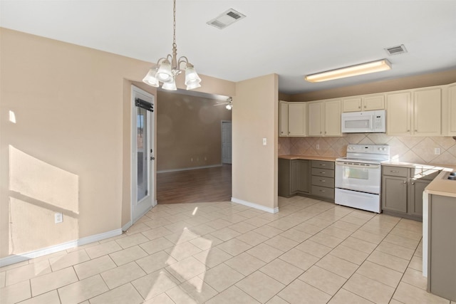 kitchen featuring ceiling fan with notable chandelier, pendant lighting, decorative backsplash, light tile patterned floors, and white appliances