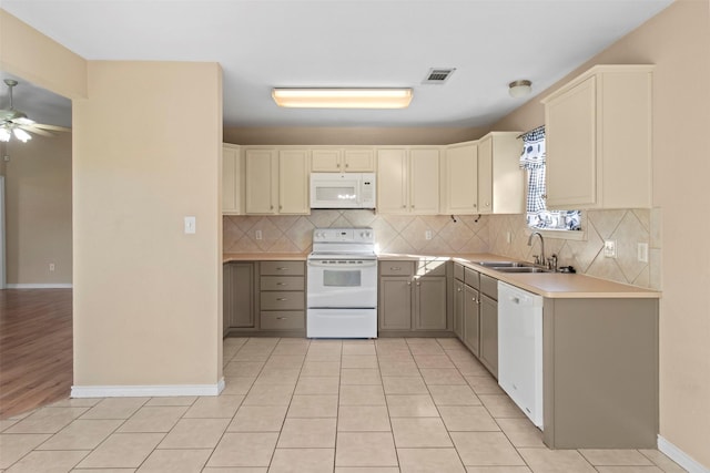 kitchen with light tile patterned floors, white appliances, sink, ceiling fan, and backsplash