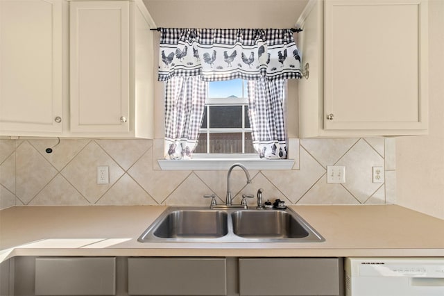 kitchen featuring white cabinetry, dishwasher, sink, and decorative backsplash