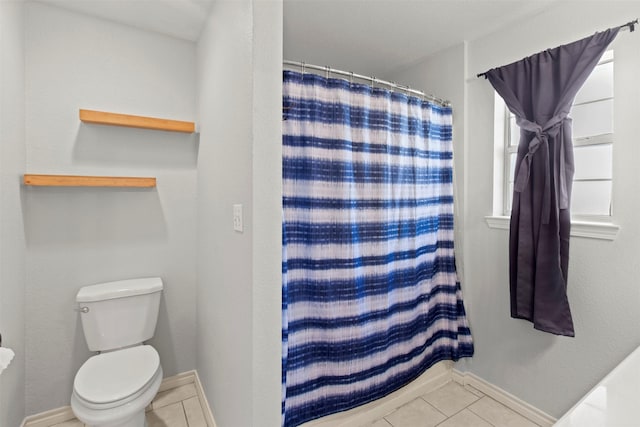 bathroom with toilet, tile patterned floors, and walk in shower