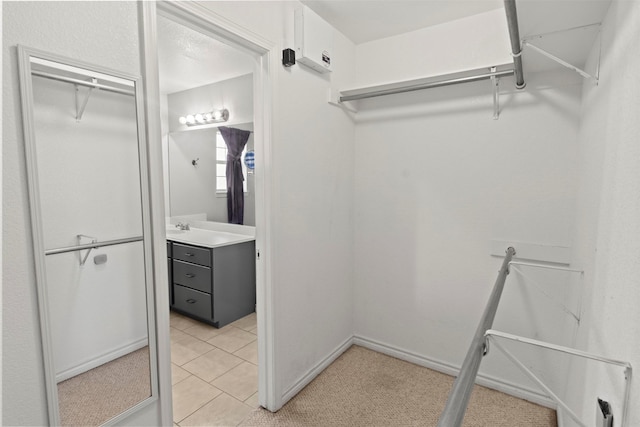 spacious closet featuring light tile patterned floors