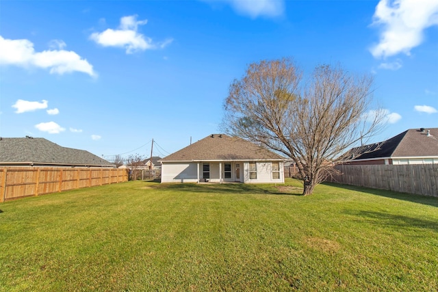 back of property featuring a yard