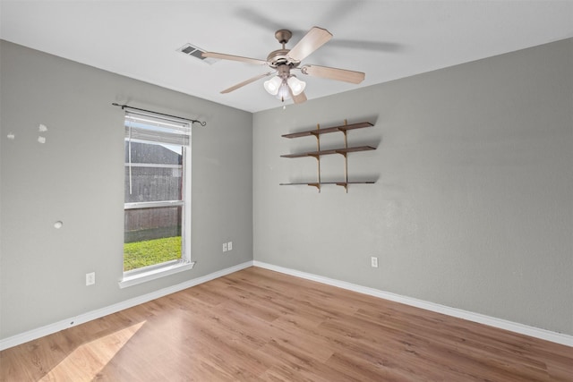 empty room with ceiling fan and light wood-type flooring