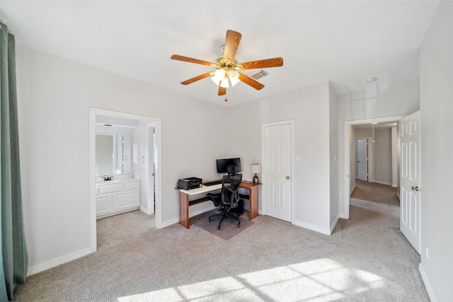 office space with light carpet, sink, and ceiling fan