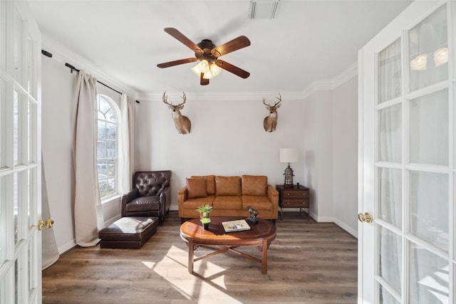 living room featuring hardwood / wood-style flooring, ceiling fan, ornamental molding, and french doors