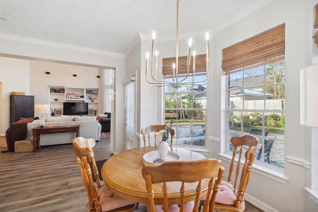 dining area with ornamental molding, hardwood / wood-style floors, and a chandelier