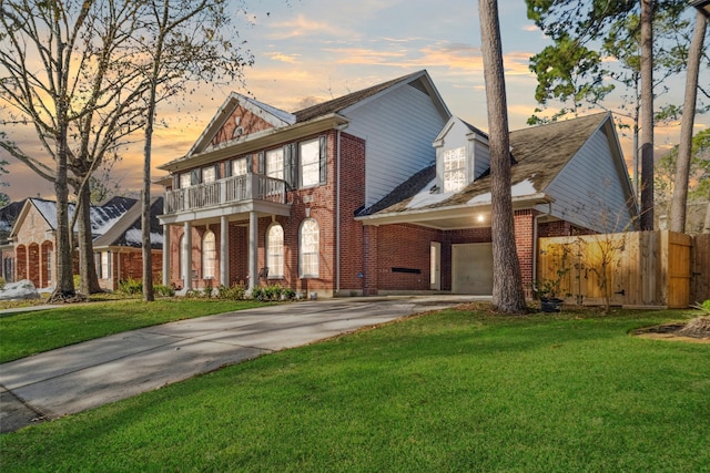 view of front of house featuring a balcony, a yard, and a carport