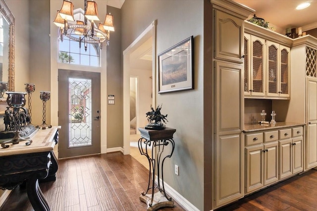 entrance foyer with dark hardwood / wood-style floors and a chandelier