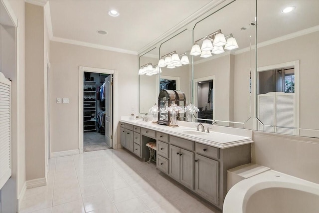 bathroom with crown molding, vanity, and tile patterned flooring