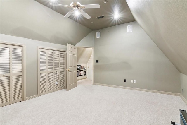 additional living space featuring vaulted ceiling, light carpet, and ceiling fan