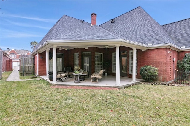 back of house featuring a yard and a patio area