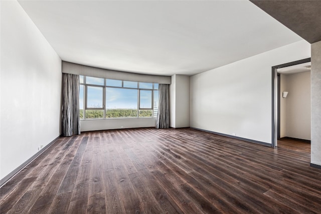 unfurnished living room with dark wood-type flooring