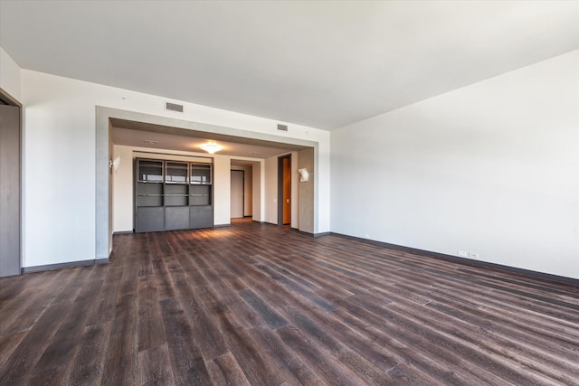 unfurnished living room with dark hardwood / wood-style floors