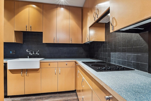 kitchen featuring black electric cooktop, dark hardwood / wood-style floors, sink, and backsplash