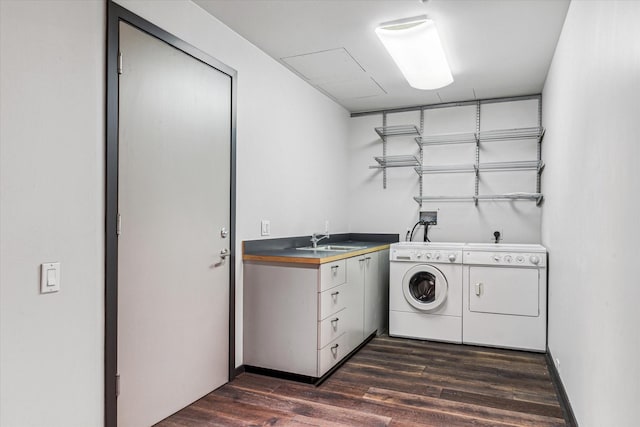 clothes washing area featuring dark wood-type flooring, cabinets, sink, and washer and dryer