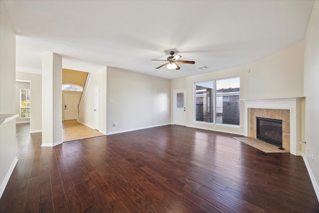 unfurnished living room with hardwood / wood-style flooring, a wealth of natural light, and a fireplace