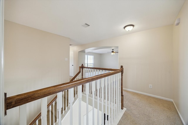 hallway featuring light colored carpet