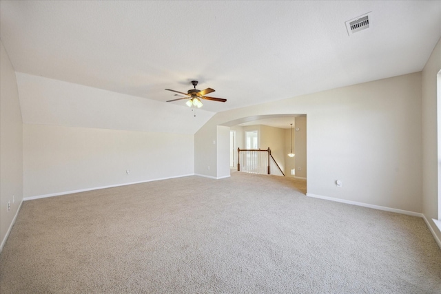 interior space featuring lofted ceiling, ceiling fan, and carpet flooring