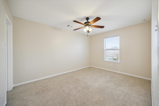 unfurnished room featuring light carpet and ceiling fan