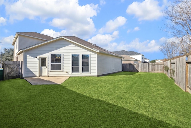 rear view of property with a patio and a yard