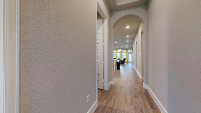 hallway with wood-type flooring