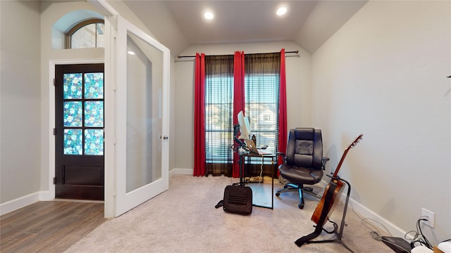 sitting room with lofted ceiling, hardwood / wood-style floors, and a healthy amount of sunlight