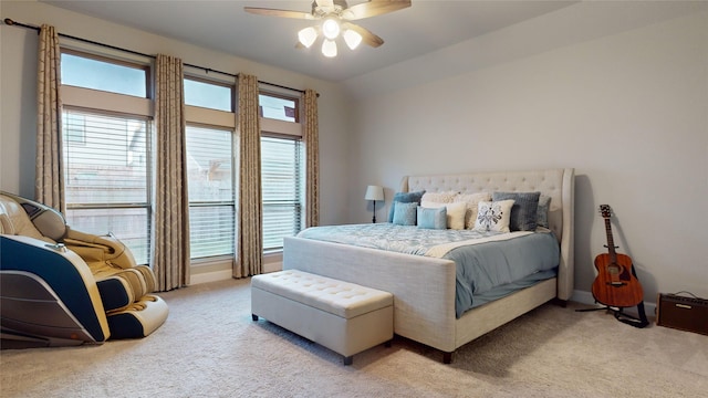 carpeted bedroom with ceiling fan, lofted ceiling, and multiple windows