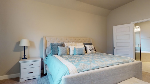 carpeted bedroom with lofted ceiling