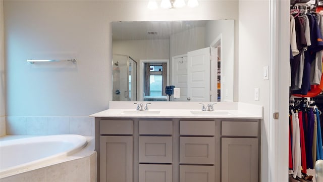 bathroom featuring vanity and separate shower and tub