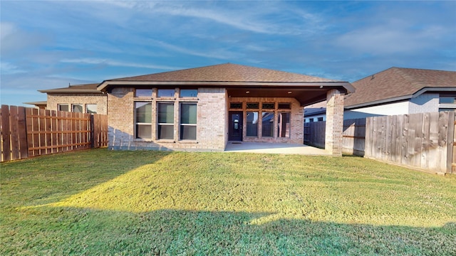 rear view of property with a patio area and a lawn