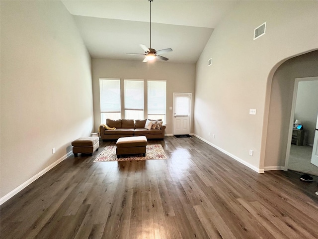 unfurnished living room with vaulted ceiling, dark hardwood / wood-style floors, and ceiling fan