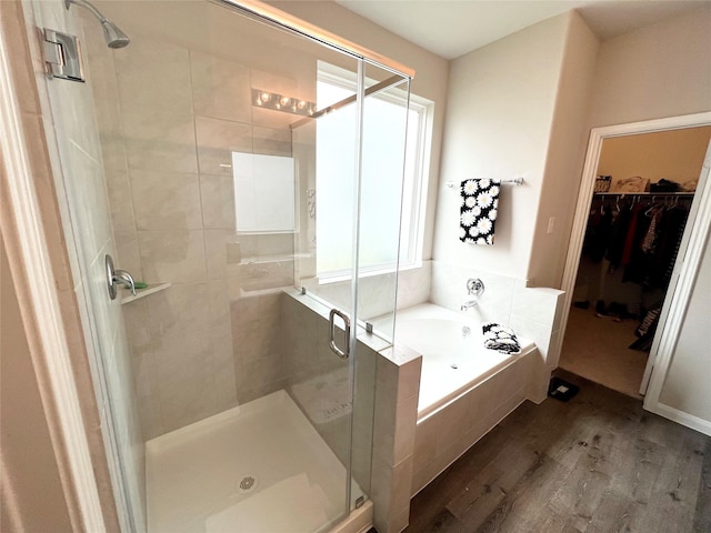 bathroom with wood-type flooring and plus walk in shower