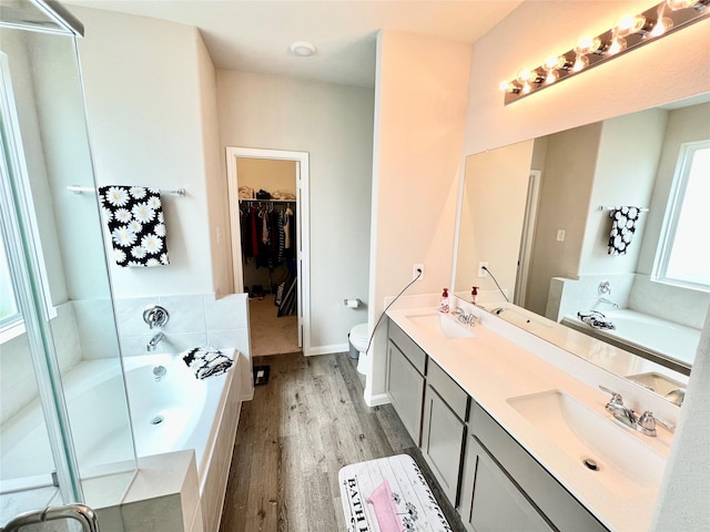 full bathroom featuring vanity, plus walk in shower, hardwood / wood-style floors, and toilet