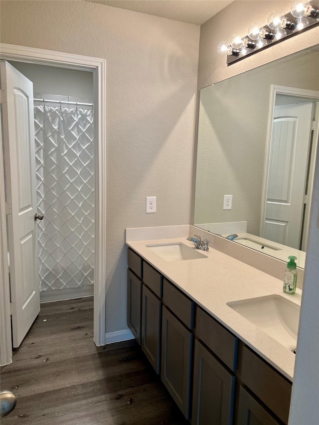 bathroom with vanity, hardwood / wood-style floors, and walk in shower