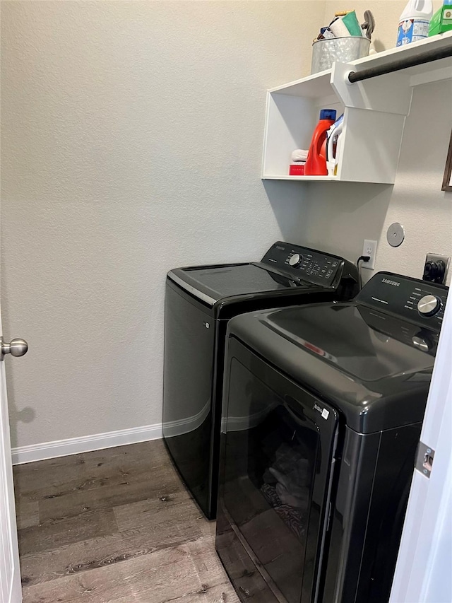 laundry room featuring separate washer and dryer and wood-type flooring