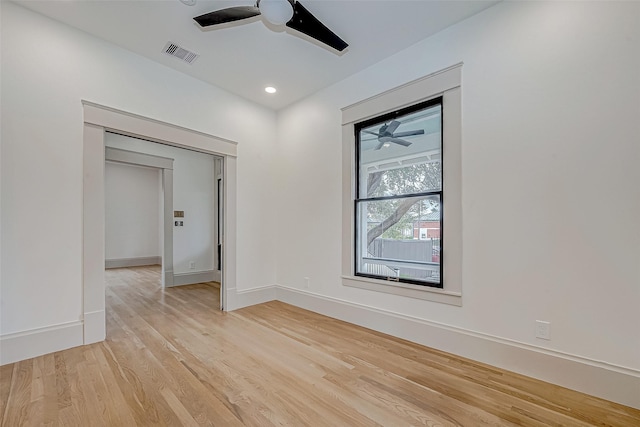 spare room with ceiling fan and light wood-type flooring