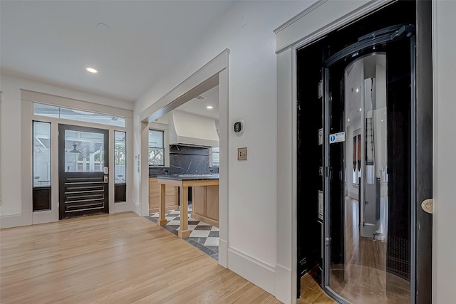 entryway with wood-type flooring