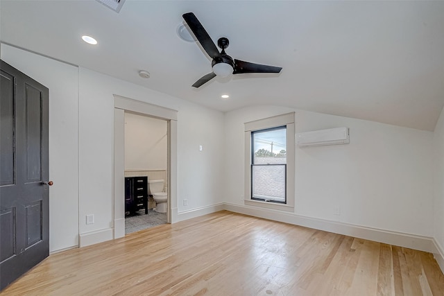 bonus room featuring vaulted ceiling, a wall mounted air conditioner, ceiling fan, and light hardwood / wood-style flooring