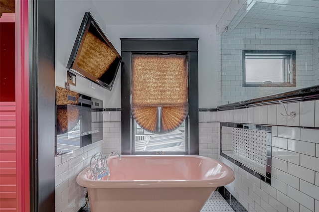 bathroom with a bathtub and tile walls