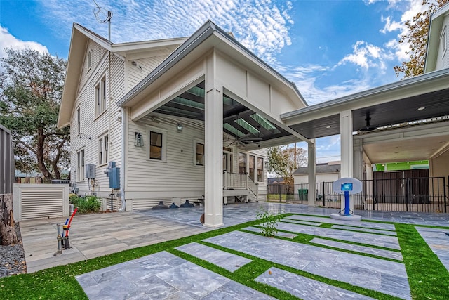 rear view of house featuring ceiling fan