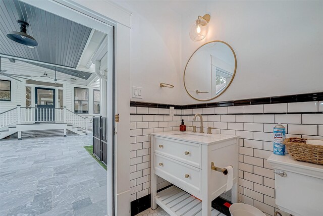 bathroom with tile walls and vanity