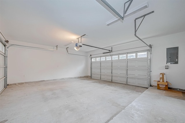 garage with a garage door opener and electric panel